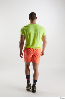 Joel  1 back view dressed green sneakers orange shorts…